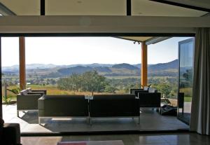 a living room with a view of the mountains at The Ridge Gloucester in Gloucester