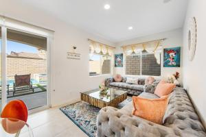 a living room with a couch and a table at Casa Whimsy in Indio