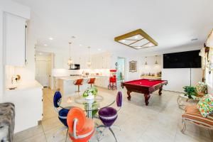 a kitchen and living room with a pool table at Casa Whimsy in Indio