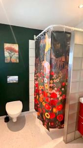 a shower curtain in a bathroom with a toilet at Vorbasse Holiday Apartments in Vorbasse