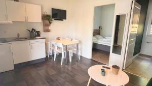 a kitchen with a table and chairs in a room at Vorbasse Holiday Apartments in Vorbasse +13 photos