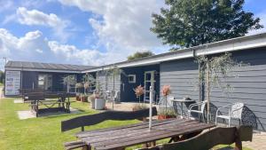 a house with a picnic table in front of it at Vorbasse Holiday Apartments in Vorbasse