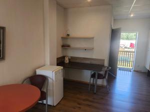 a kitchen with a table and chairs in a room at Vieta tavai atputai ar grilu in Liepāja