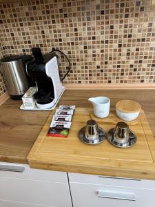 a counter top with a coffee maker and bowls on it at Апартамент “Djanina 2” in Sandanski