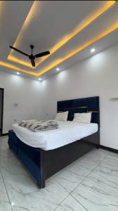 a bed in a room with a ceiling fan at Hotel River View in Ghaziabad