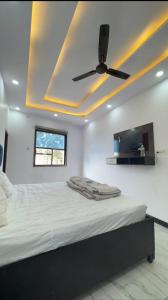 a bedroom with a ceiling fan and a bed at Hotel River View in Ghaziabad