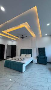 a bedroom with a bed and a chair in a room at Hotel River View in Ghaziabad