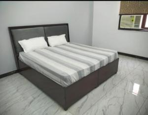 a bed with two pillows on it in a room at Hotel River View in Ghaziabad