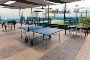 a ping pong table on a tennis court at villa oltremare resort in Bagheria
