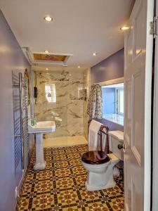 a bathroom with a toilet and a sink at Tower Hotel in Oxton