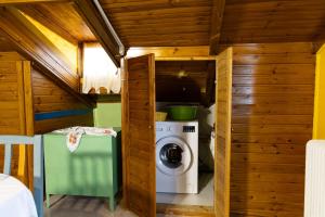 a washer and dryer in a tiny house at Pool house Axiothea in Neméa