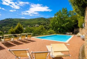 a swimming pool with a bunch of chairs and a table at Riviera Panorama Retreat in Alassio