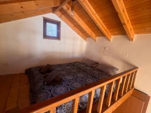 an attic bedroom with a bed in a cabin at Princeps De Cura Traditional in Symi
