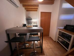 a kitchen with a counter and stools in a room at Princeps De Cura Traditional in Symi