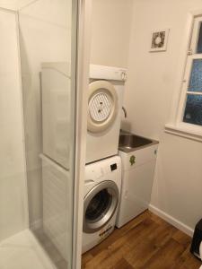 a washer and dryer in a small room at Larsen Apartment in Palmerston North