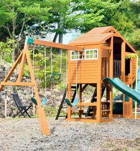 a playground with a play structure and a slide at Foresta Karuizawa 3 in Miyota