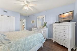 a bedroom with a bed and a tv on a dresser at Oceanwalk 9-604 in New Smyrna Beach +71 photos