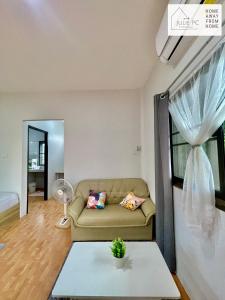a living room with a couch and a table at Temple House by Julie PC in Ko Phangan