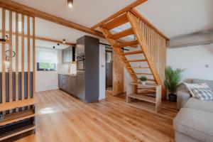 a living room with a staircase and a kitchen at Hiša pri Lipi in Pristava pri Mestinju