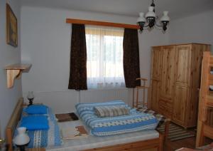 a bedroom with a bed and a window at Mura Vendégház in Murakeresztúr
