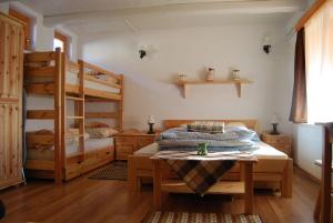a bedroom with two bunk beds and a table at Mura Vendégház in Murakeresztúr +32 photos