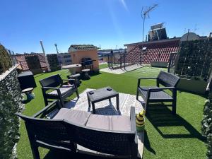 a patio with chairs and a table and a grill at ARIEL'S house in San Benedetto del Tronto