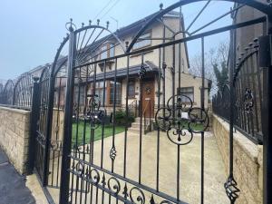 an iron gate to a house with a building at Silverhill in Bradford