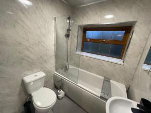 a bathroom with a toilet and a shower and a sink at Silverhill in Bradford +61 photos