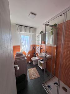 a bathroom with a shower and a toilet and a sink at ARIEL'S house in San Benedetto del Tronto +10 photos