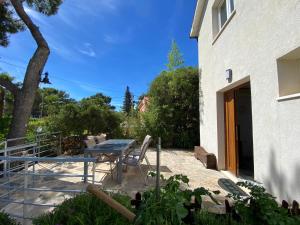 a patio with a table and chairs next to a building at Apartmani Huljić in Stari Grad +8 photos
