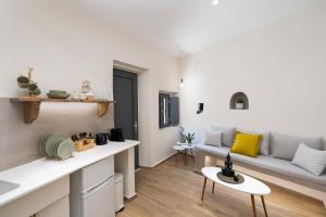 a living room with a couch and a table at Petit Suite in Emporio