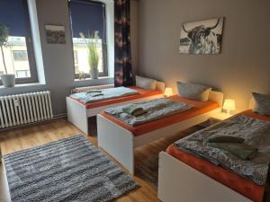 a room with three beds and a window at Flensburg City 4 1 in Flensburg