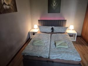 a bedroom with a large bed with two pillows at Flensburg City 4 1 in Flensburg