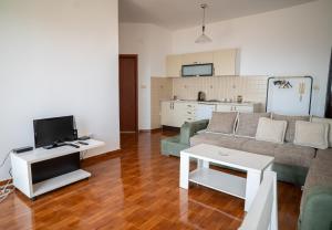 a living room with a couch and a tv at Apartments Oasis in Budva