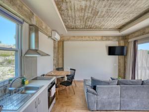 a kitchen and living room with a couch and a table at Kochylari Apartments in Kefalos