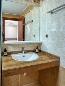 a bathroom with a sink and a mirror at Kochylari Apartments in Kefalos +25 photos
