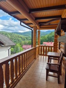 a balcony with a view of the mountains at Княжий двір in Yaremche