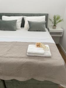 a white bed with a towel on top of it at The White House Split in Split
