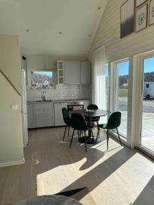 a kitchen and dining room with a table and chairs at Reinholds Gästhus in Kareby