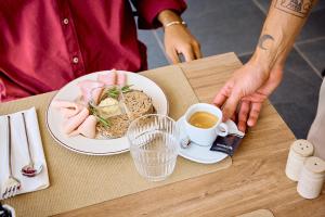 a table with a plate of food and a cup of coffee at Quinta dos Vales Wine Estate in Lagoa +80 photos