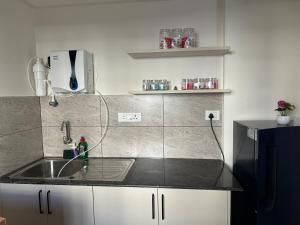 a kitchen with a sink and a counter top at North scape 104 in Bangalore +20 photos