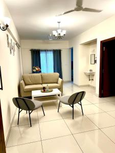 a living room with a couch and a table and chairs at North scape 104 in Bangalore