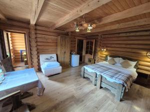 a bedroom with a bed in a log cabin at Княжий двір in Yaremche