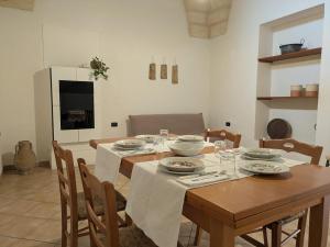 a dining room with a wooden table and chairs at Casa Santa Iaca in Vitigliano +5 photos