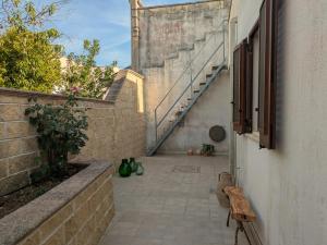 a hallway with a stairway leading up to a building at Casa Santa Iaca in Vitigliano