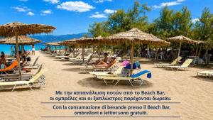 a row of chairs and umbrellas on a beach at Nonna Sofia in Krikellos +11 photos