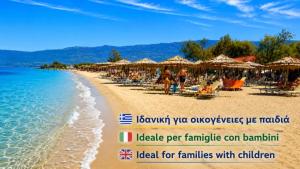 a beach with umbrellas and people sitting on the sand at Nonna Sofia in Krikellos