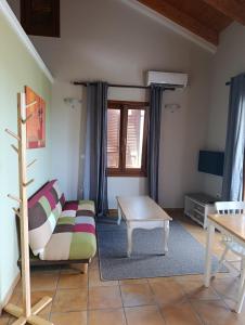 a living room with a couch and a coffee table at Tesoro of Ithaca in Stavros