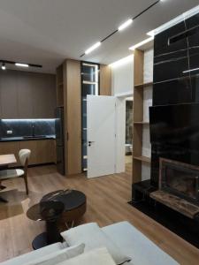 a living room with a fireplace and a white door at Vila 1985 in Tirana