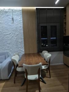 a room with a table and chairs and a bed at Vila 1985 in Tirana